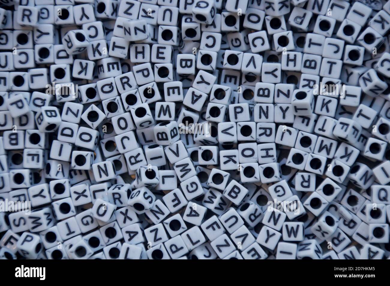 Cluster of white cube-shaped beads with black letters. Stock Photo