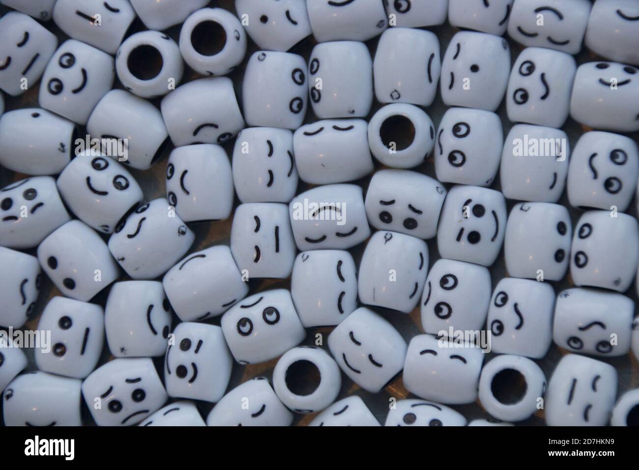 Cluster of white round shaped beads with smiles/faces. Stock Photo