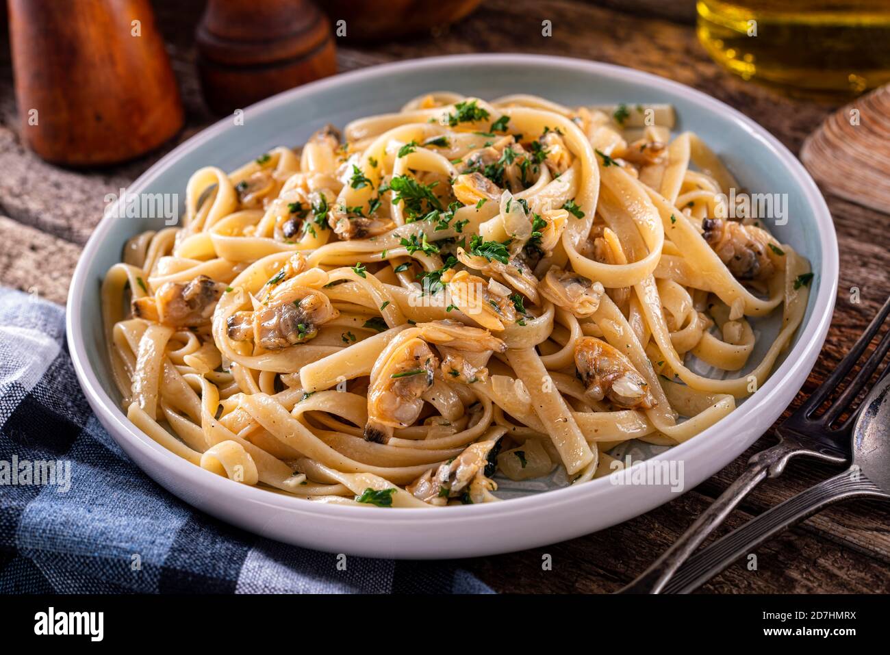 A plate of delicious pasta with clam sauce with onion, garlic, olive oil, parsley and fresh clams. Stock Photo