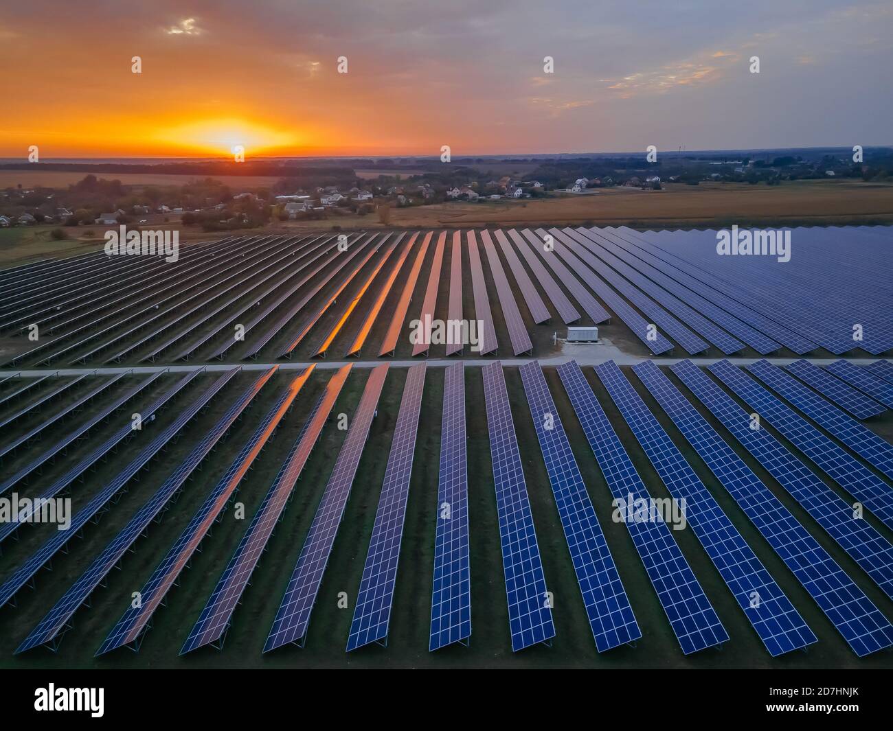 Aerial drone view of large solar panels at a solar farm at bright ...
