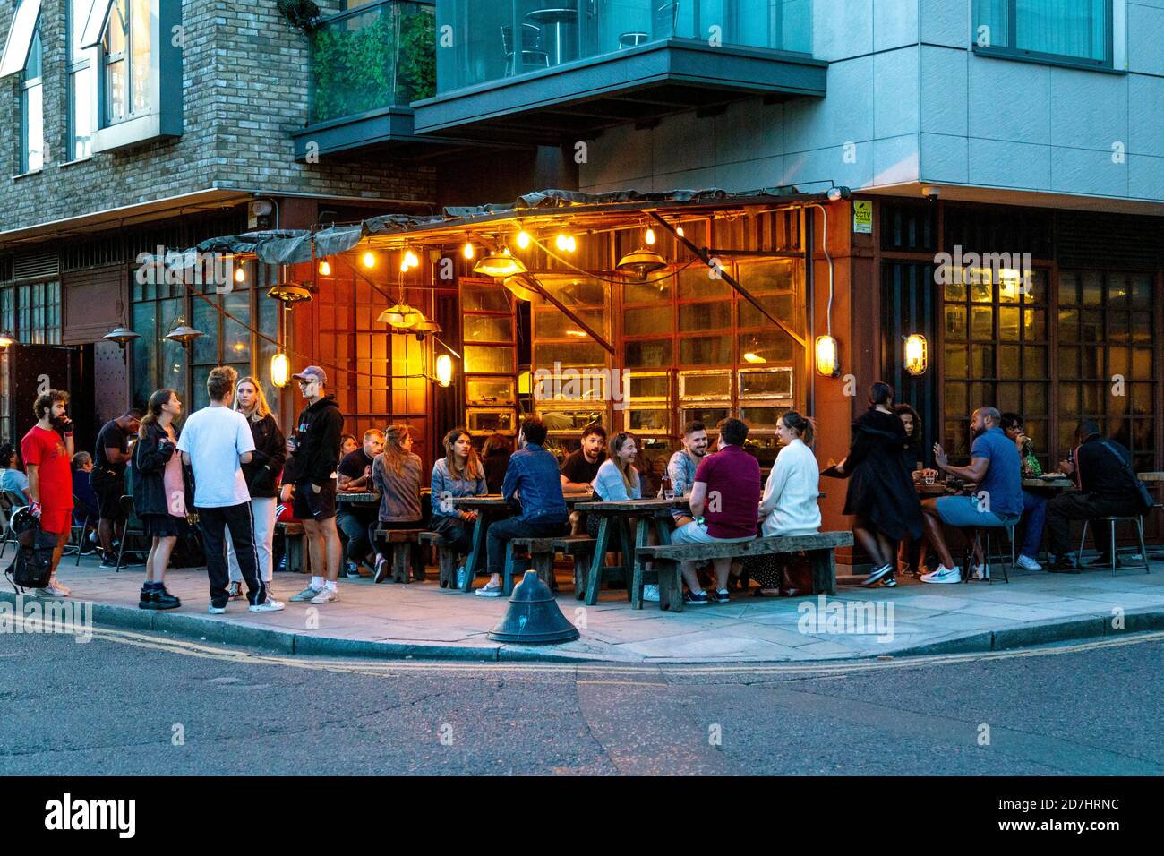 People dining at SMOKESTAK London barbecue in the evening, Shoreditch, London, UK Stock Photo