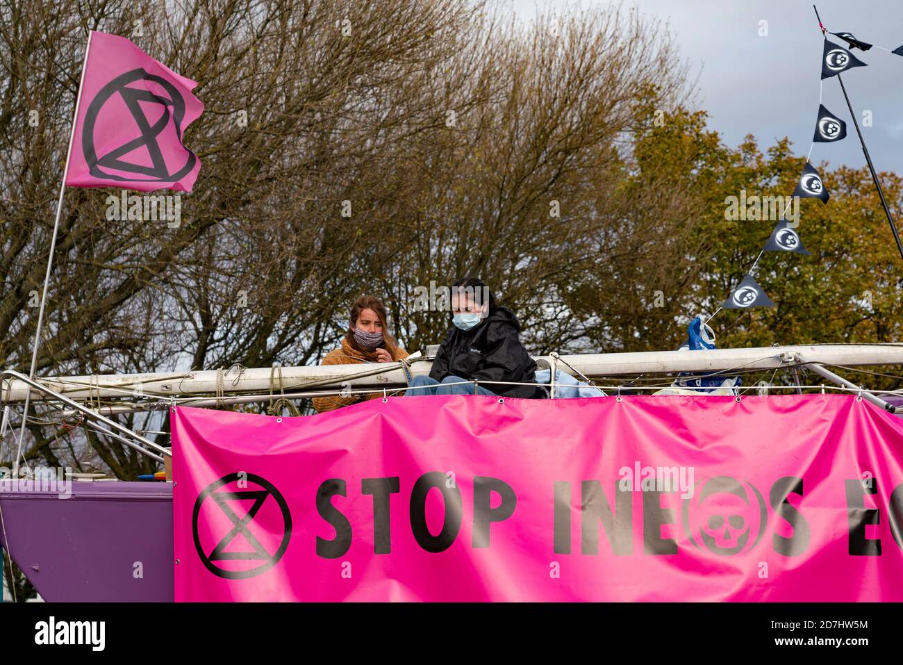 Grangemouth, Scotland, UK. 23 October 2020. Extinction Rebellion climate change protesters block entrance to INEOS headquarters at Grangemouth. Protesters have locked themselves together with chain and have parked a yacht in the road blocking access. Police have closed Inchyra Road. Iain Masterton/Alamy Live News Stock Photo