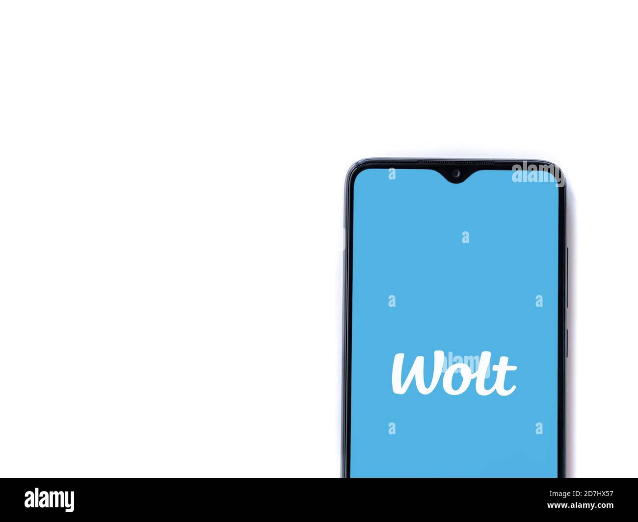 Lod, Israel - July 8, 2020: Wolt app launch screen with logo on the display of a black mobile smartphone isolated on white background. Top view flat l Stock Photo