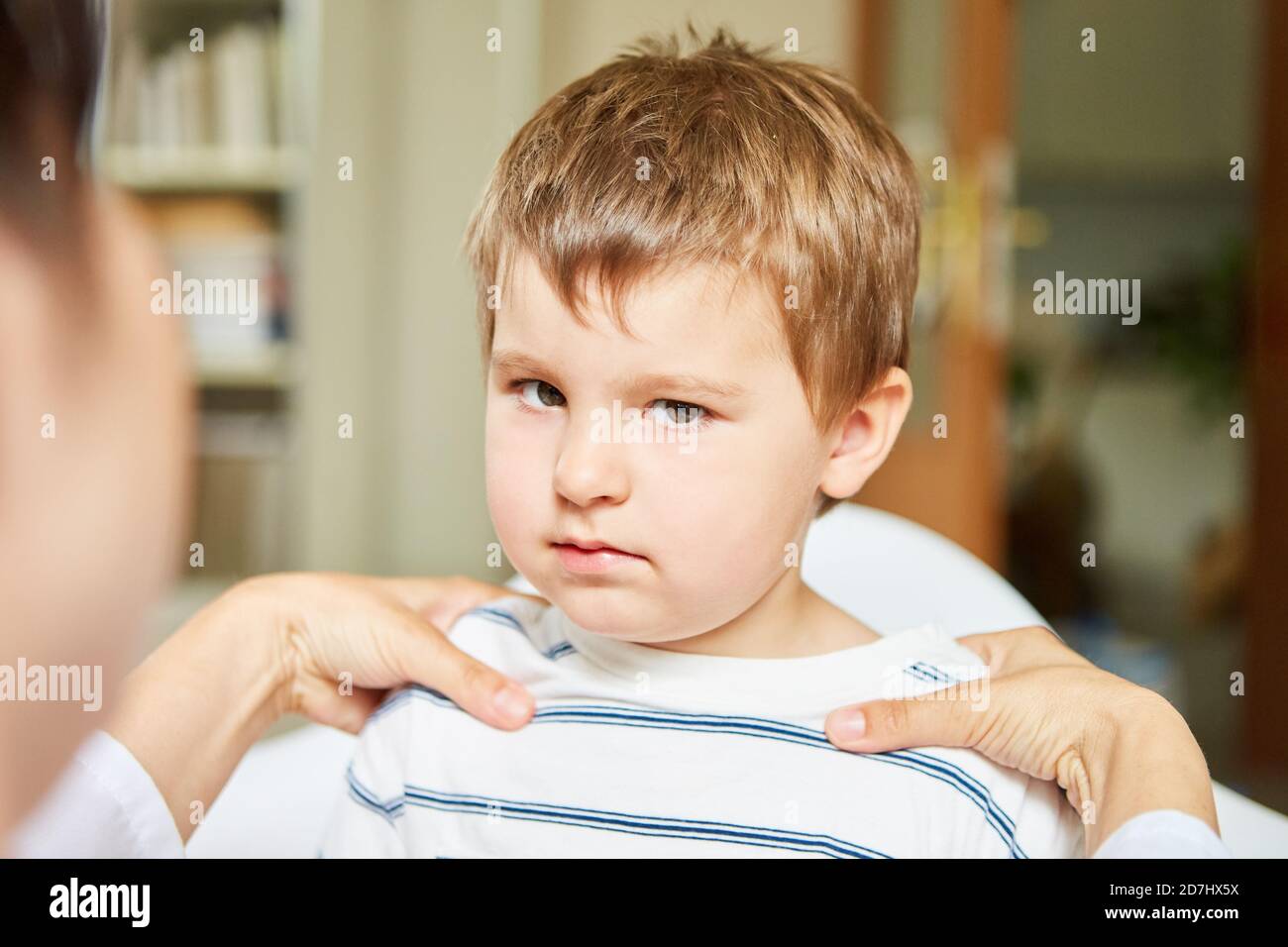 Anxious child undergoing osteopathy or chiropractic therapy because of