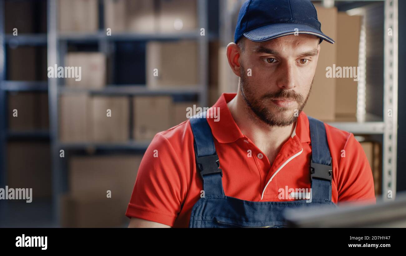 Portrait of Uniformed Worker Using Personal Computer while Sitting at ...