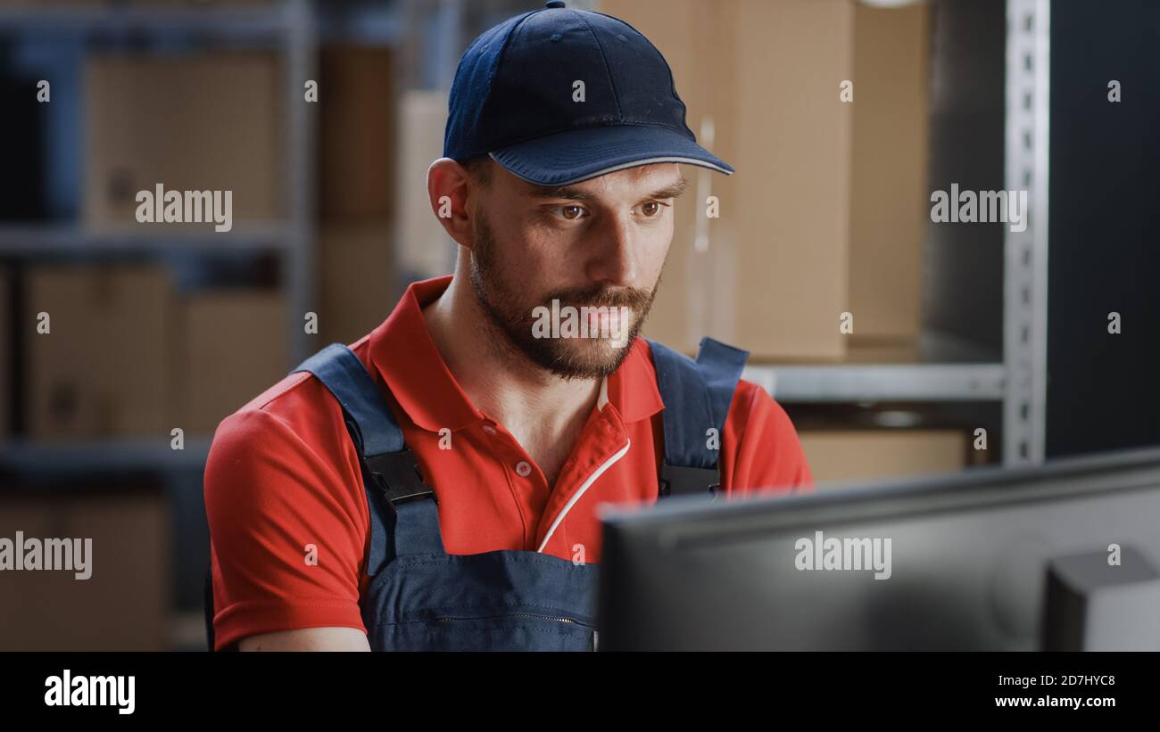 Portrait of Uniformed Worker Using Personal Computer while Sitting at ...