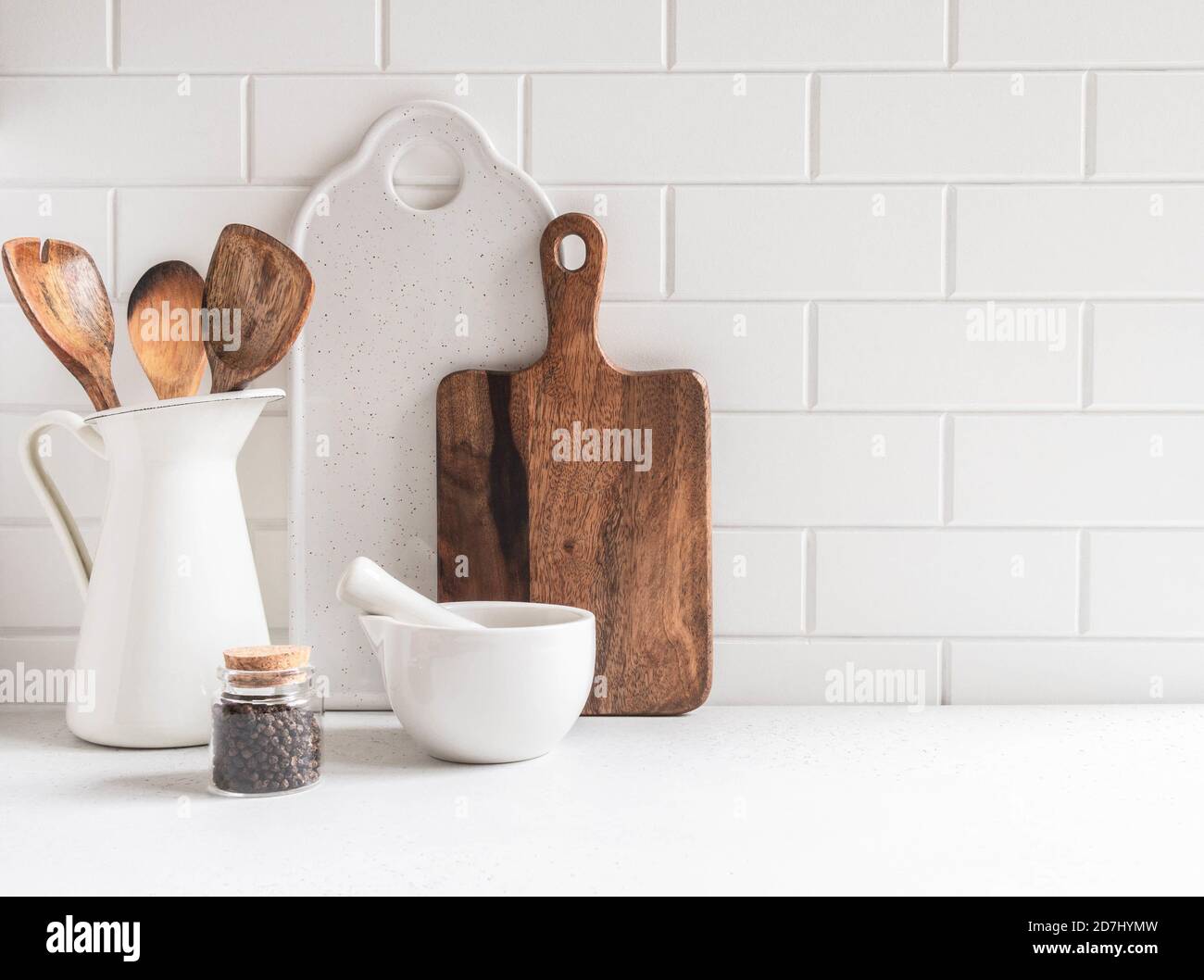 Stylish white kitchen background with kitchen utensils on white