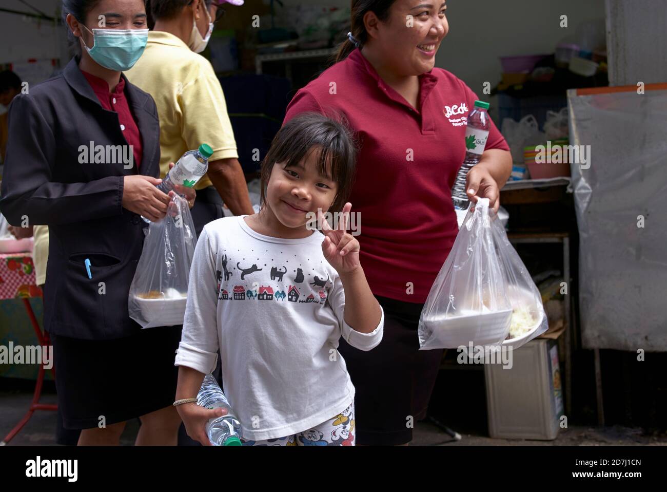Children receiving free food in celebration of Chulalongkorn Day, King Rama V, Thailand Southeast Asia Stock Photo