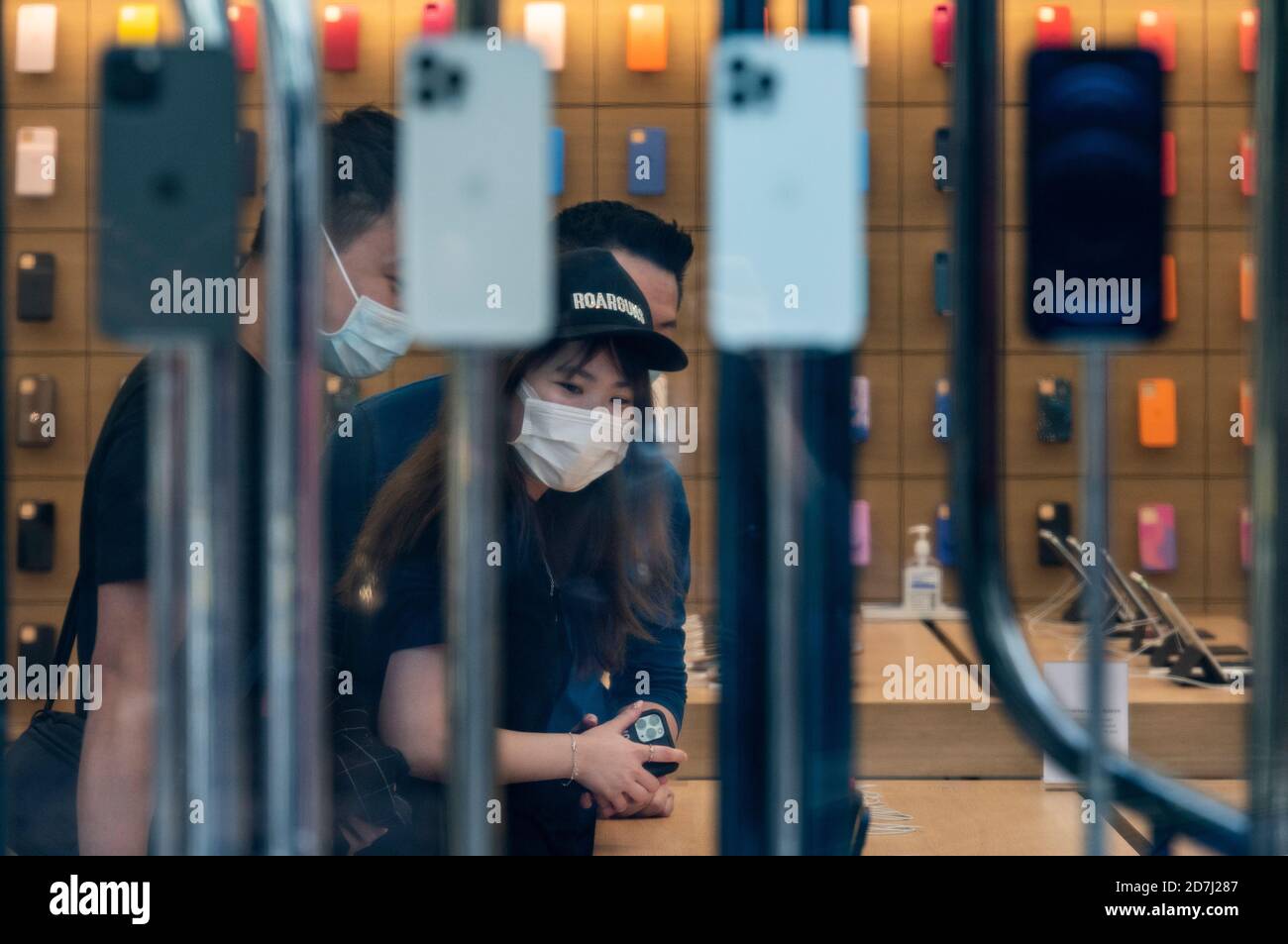 A Salesperson and Customers at an Apple Store Looking at the Latest Apple  IPhone 12 Models for Sale Editorial Stock Photo - Image of consumerism,  design: 203627358