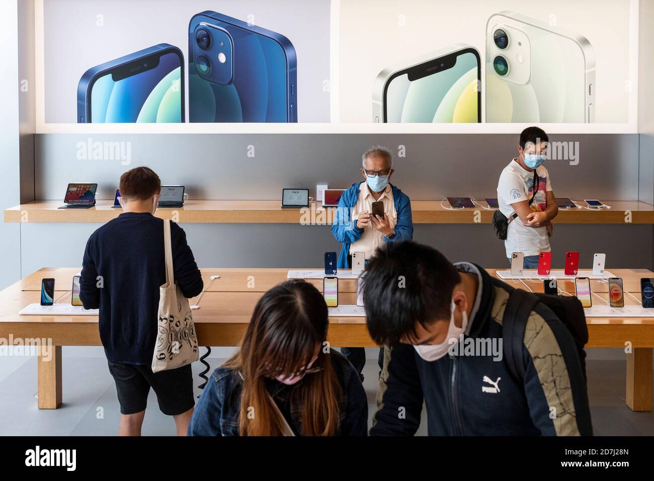 A Salesperson and Customers at an Apple Store Looking at the Latest Apple  IPhone 12 Models for Sale Editorial Stock Photo - Image of consumerism,  design: 203627358