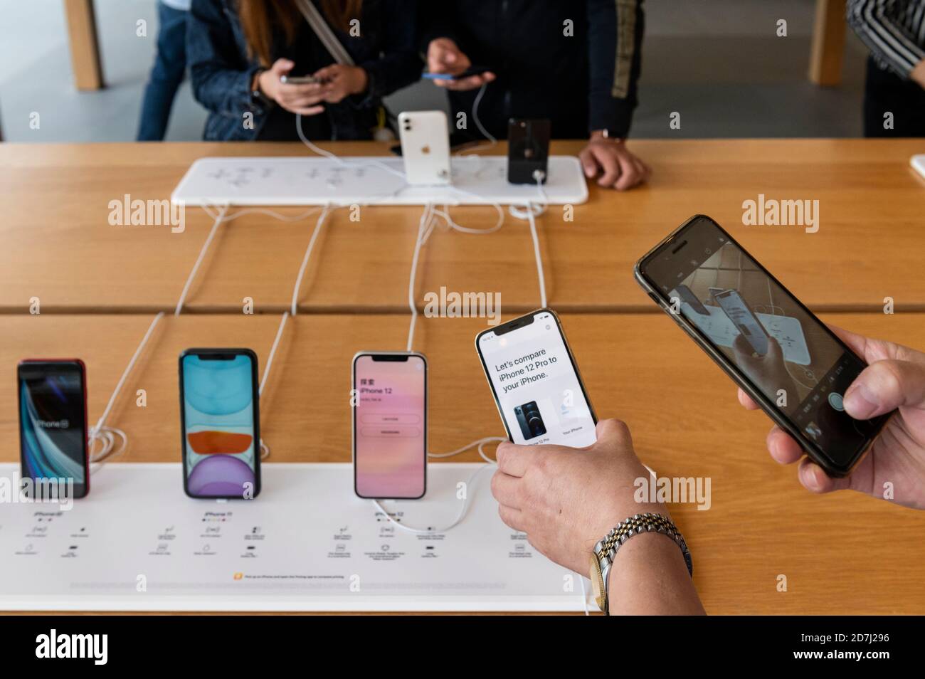 Customers testing Apple brand products at an Apple store during