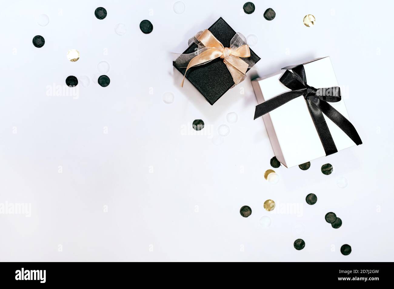 Black and white gift or present boxes and confetti on white background