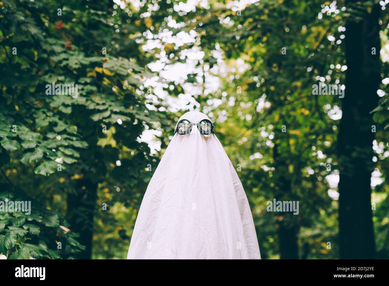 Child in forest wearing ghost Halloween costume Stock Photo - Alamy