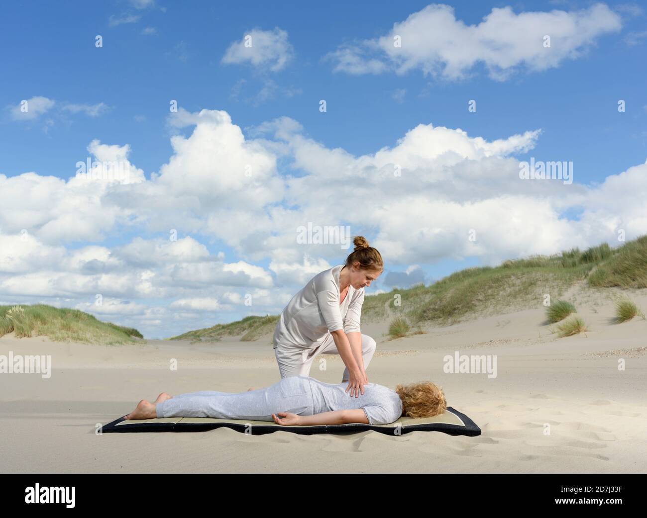 A professional masseuse at work on sand dunes, Oostkapelle, Zeeland, the Netherlands Stock Photo
