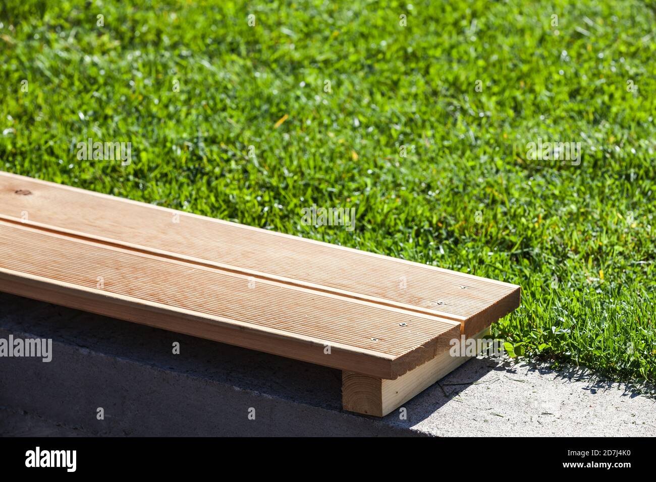 Empty wooden outdoor bench fragment. Home garden background photo Stock Photo