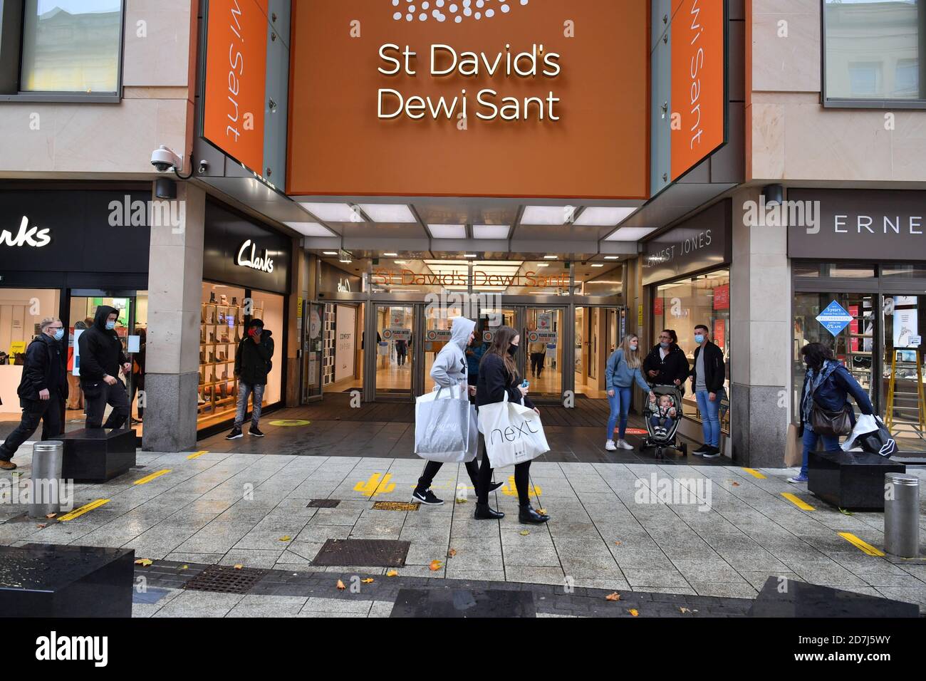 Shoppers walk past the St David's shopping arcade on Queen Street in  Cardiff before Wales will enter a two-week "firebreak" lockdown at 6pm on  Friday in an attempt to protect the country's