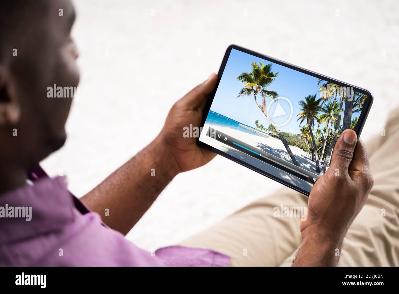 Young African Man Watching Video On Tablet Stock Photo