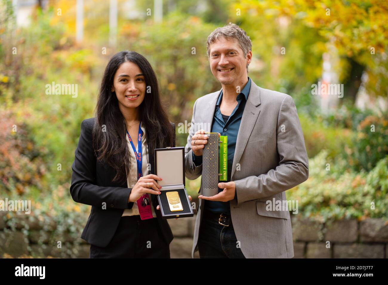 Hof, Germany. 23rd Oct, 2020. The director Sevgi Hirschhäuser and her husband and cameraman Chris Hirschhäuser hold a 1kg gold bar and the Hofer gold price in their hands. Sevgi's debut film 'Tobrak' received the Hofer Gold Prize because it is 'a unique and in its pictures absolutely unmistakable narrative', the Hofer Filmtage announced on Friday (23.10.20). Credit: Nicolas Armer/dpa/Alamy Live News Stock Photo