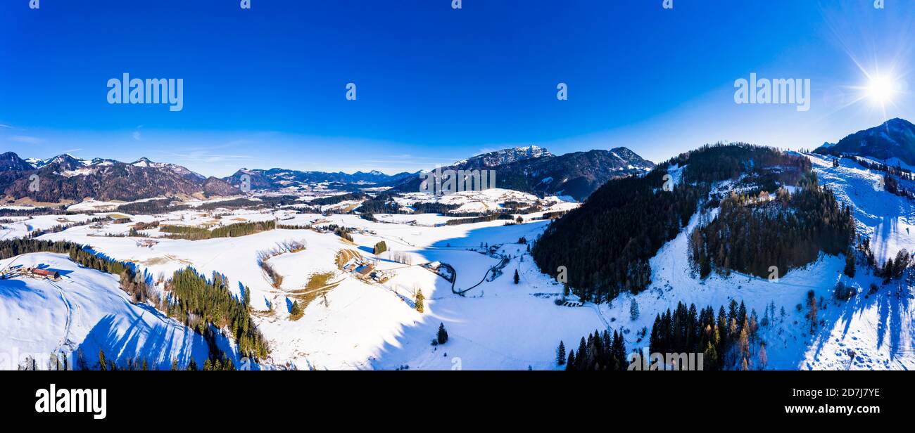 Austria, Tyrol, Kossen, Helicopter panorama of mountain village in snow-covered Leukental valley Stock Photo