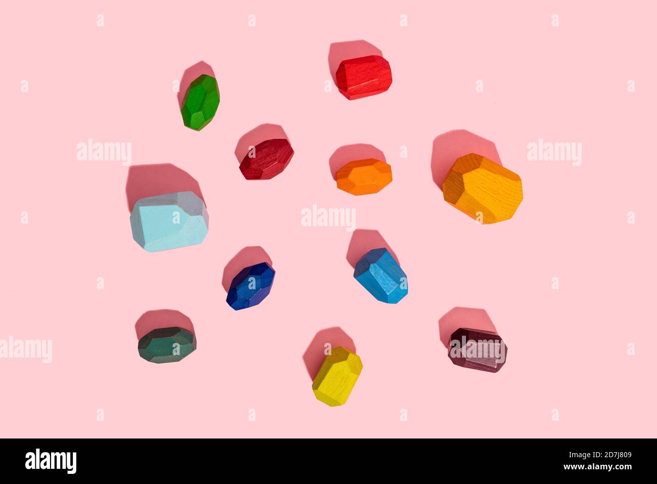 Multi colored wooden blocks against pink background Stock Photo
