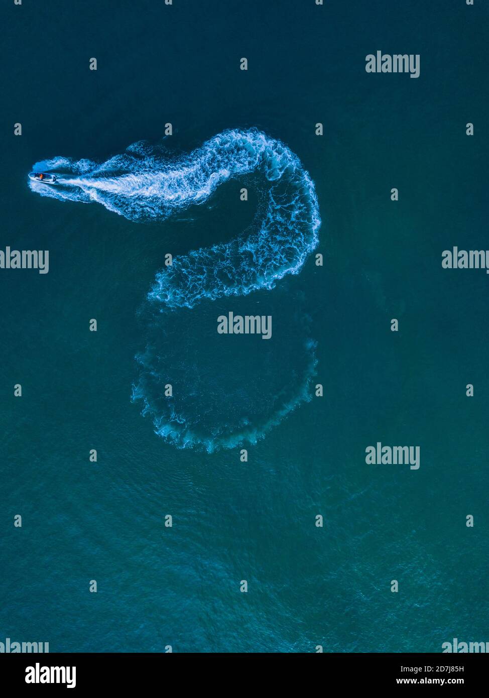 Aerial view of jet boat sailing in turquoise water Stock Photo - Alamy