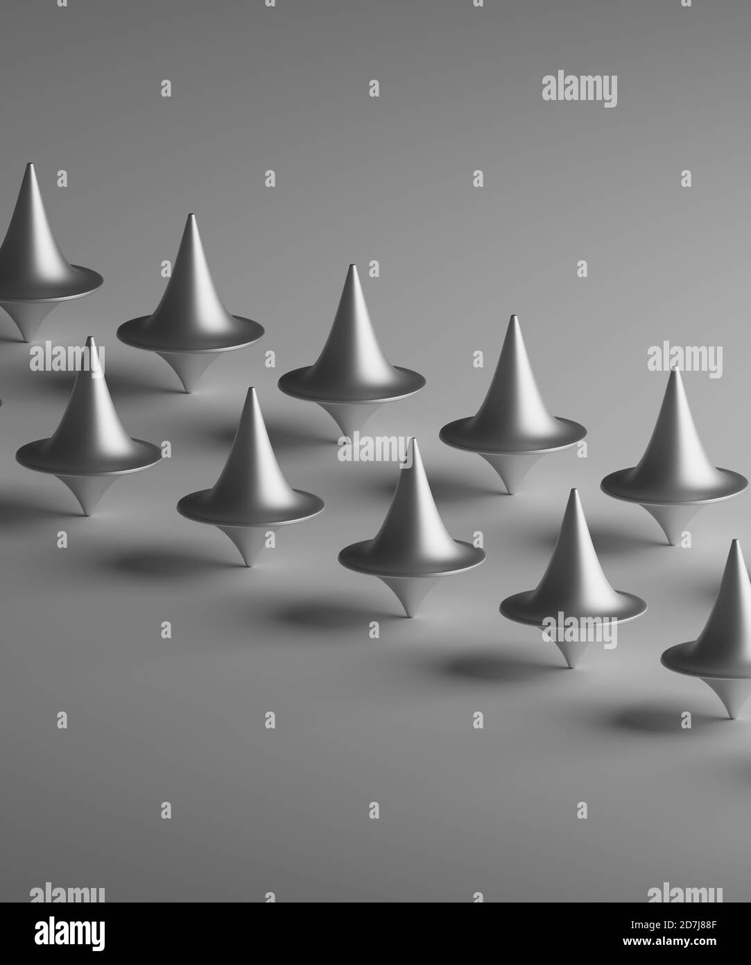 Three dimensional render of rows of metallic spinning tops Stock Photo