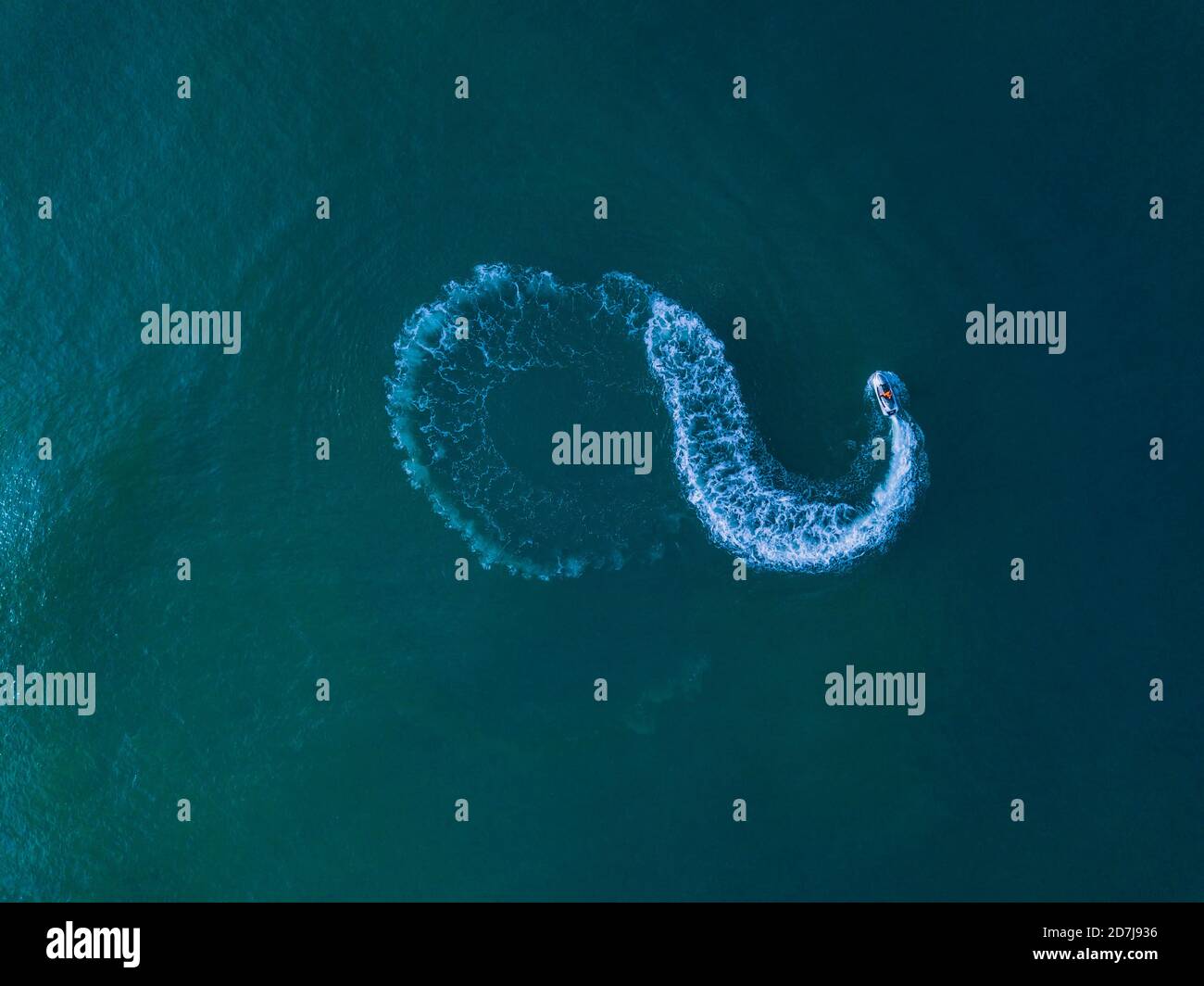 Aerial view of jet boat sailing in turquoise water Stock Photo - Alamy