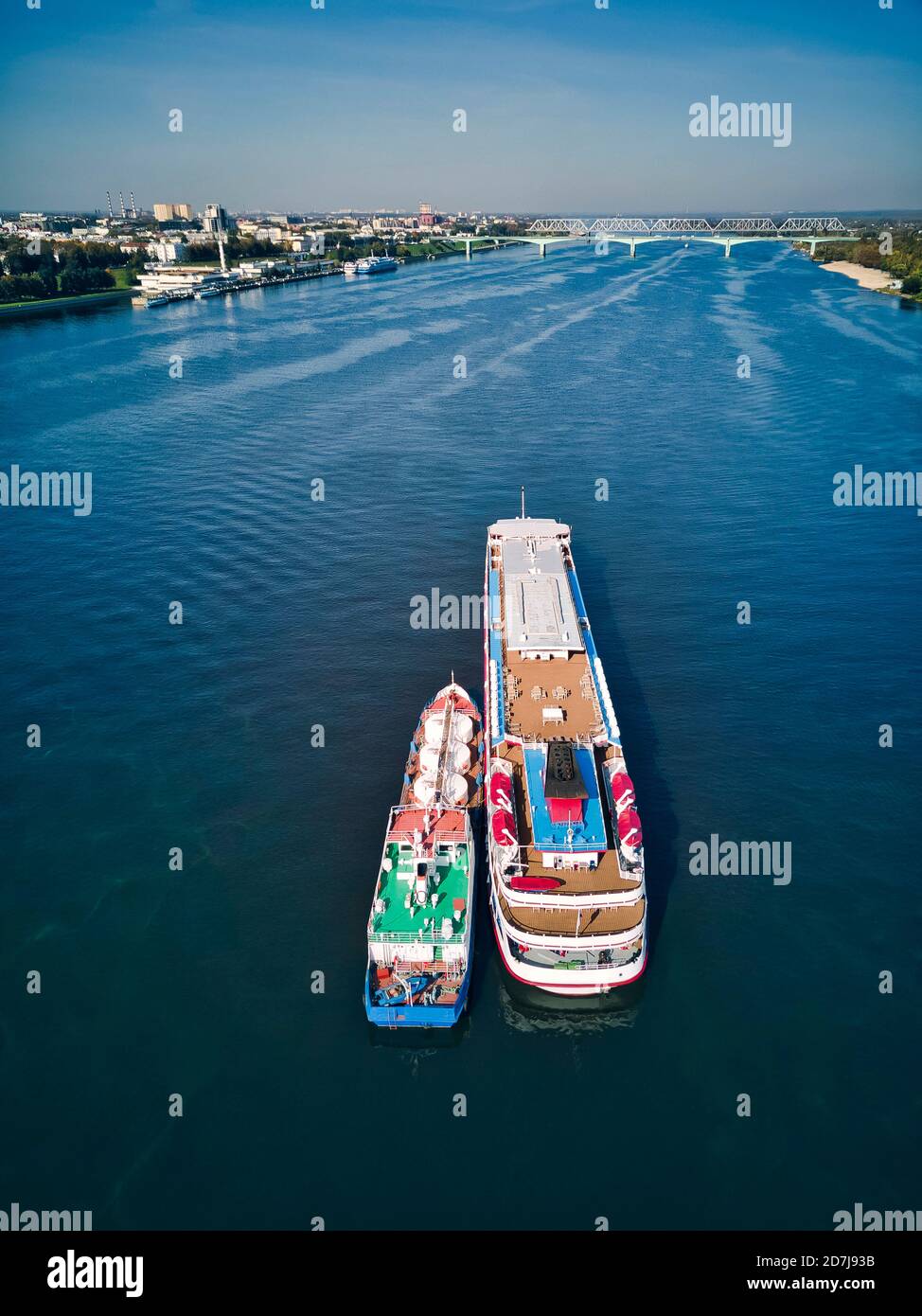 Barge refueling recreational boat on Volga River against sky Stock Photo