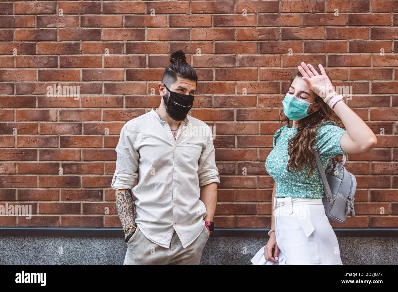 Man woman couple looking wearing face mask masks covid 19 hires stock