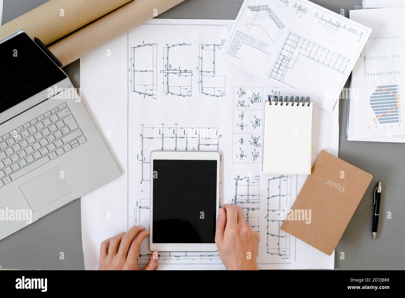 Man using digital tablet while working by desk at office Stock Photo