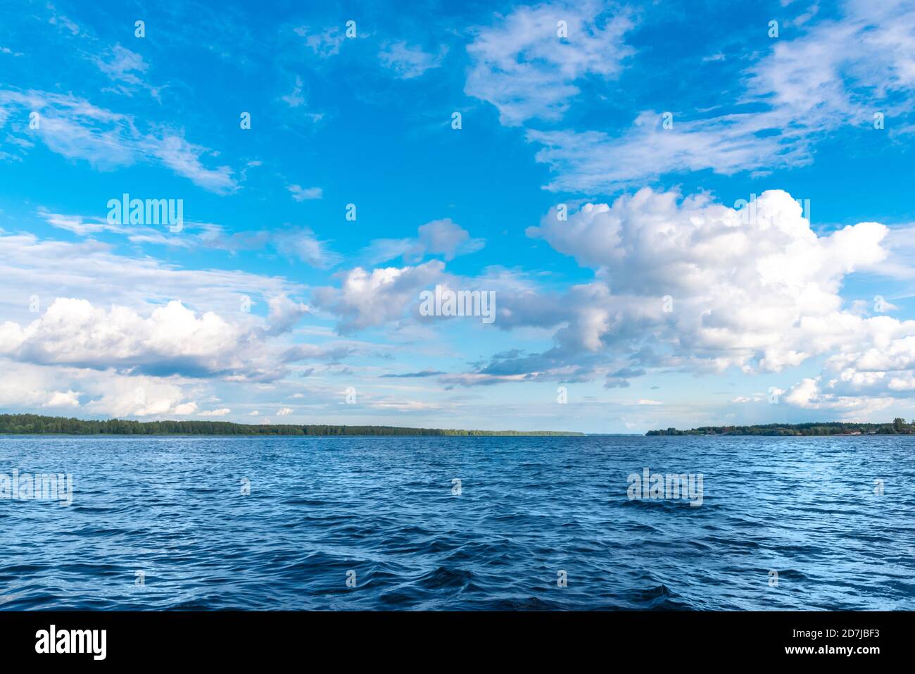 Landscape with calm river under blue sky with white clouds Stock Photo ...