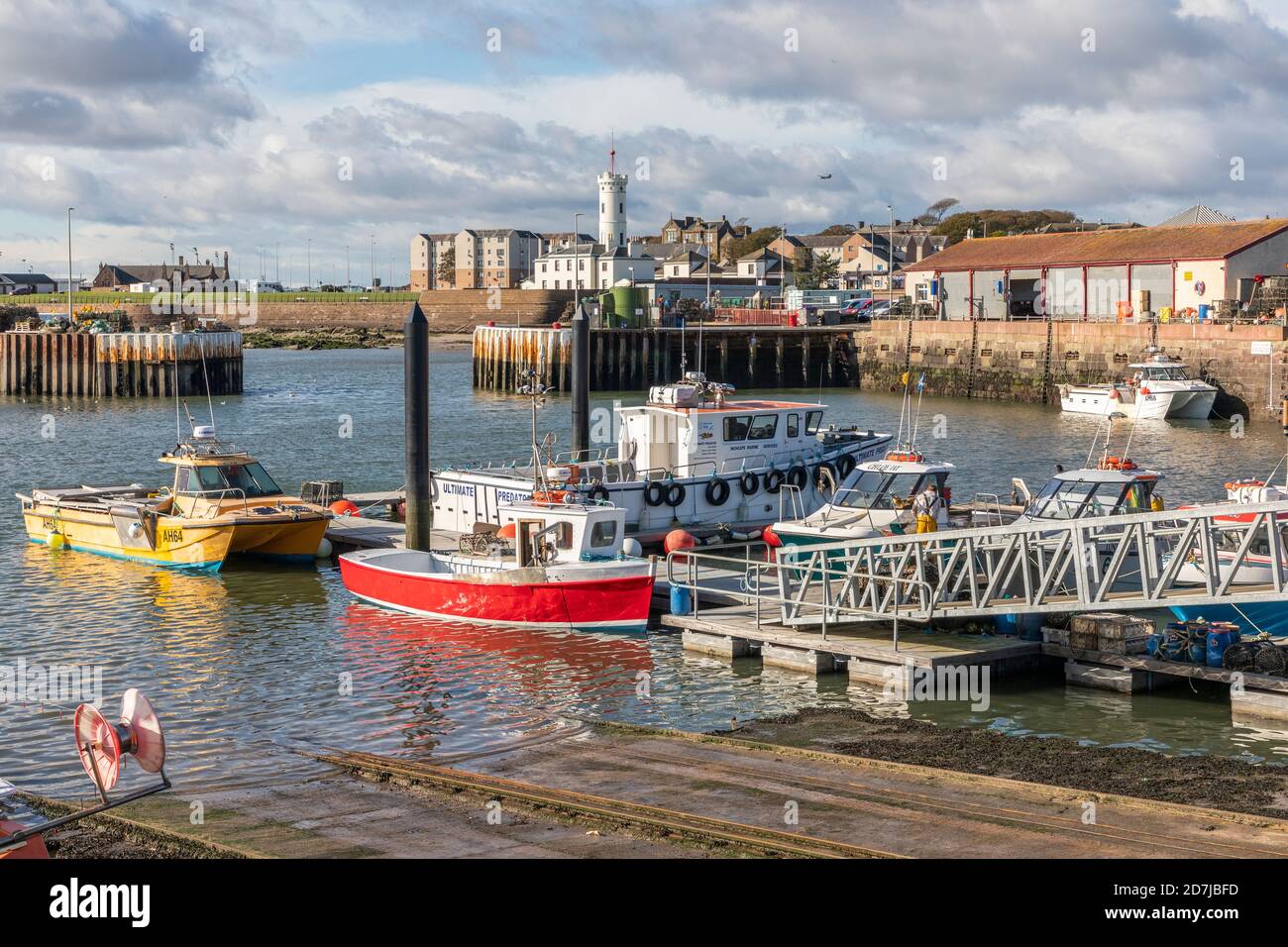 Small boats, fishing boats and pier at Arbroath harbour, Arbroath, Angus, Scotland, UK Stock Photo