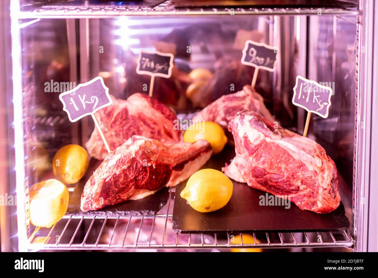 Meat and lemons in refrigerator Stock Photo