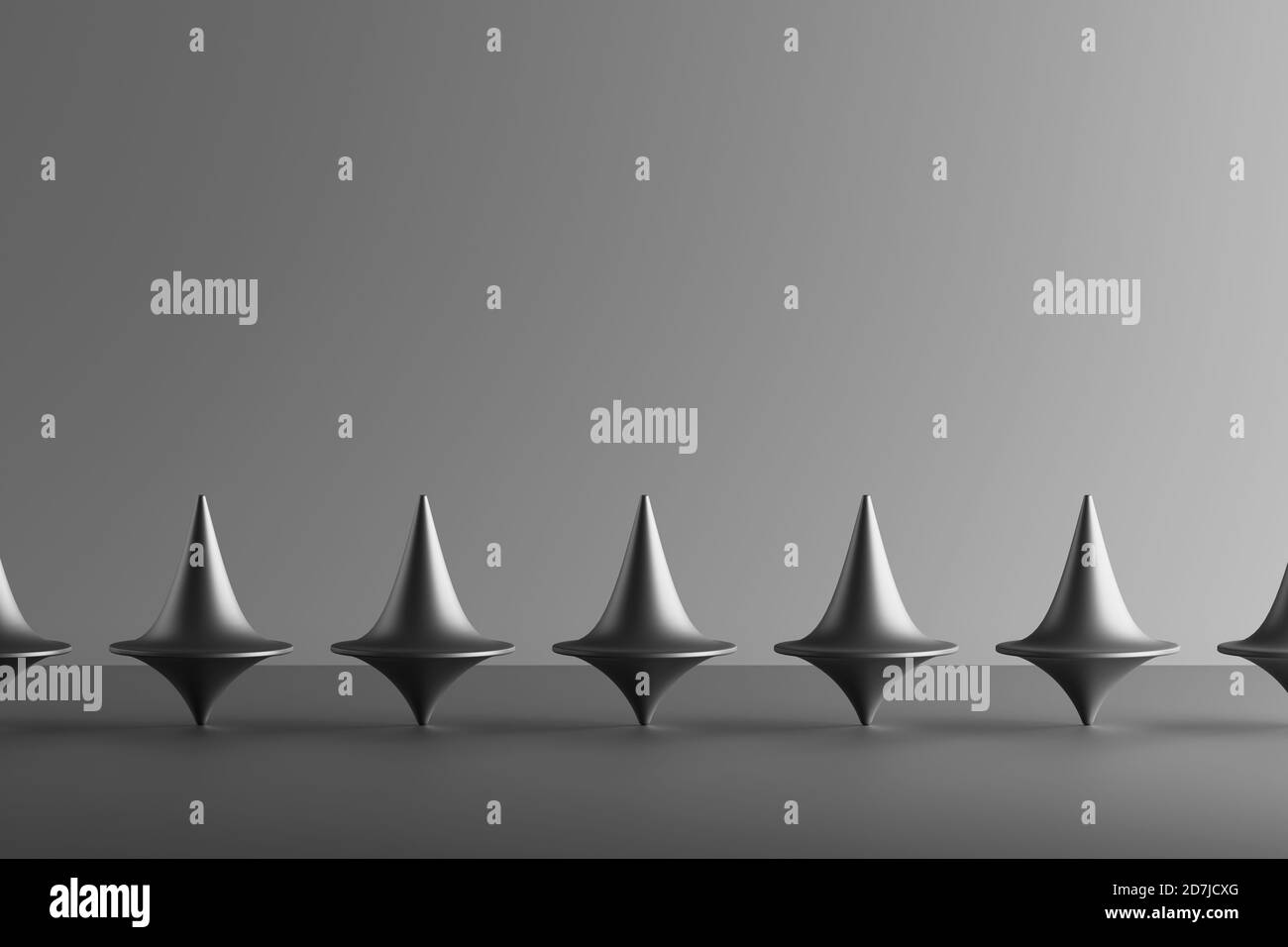Three dimensional render of row of metallic spinning tops Stock Photo