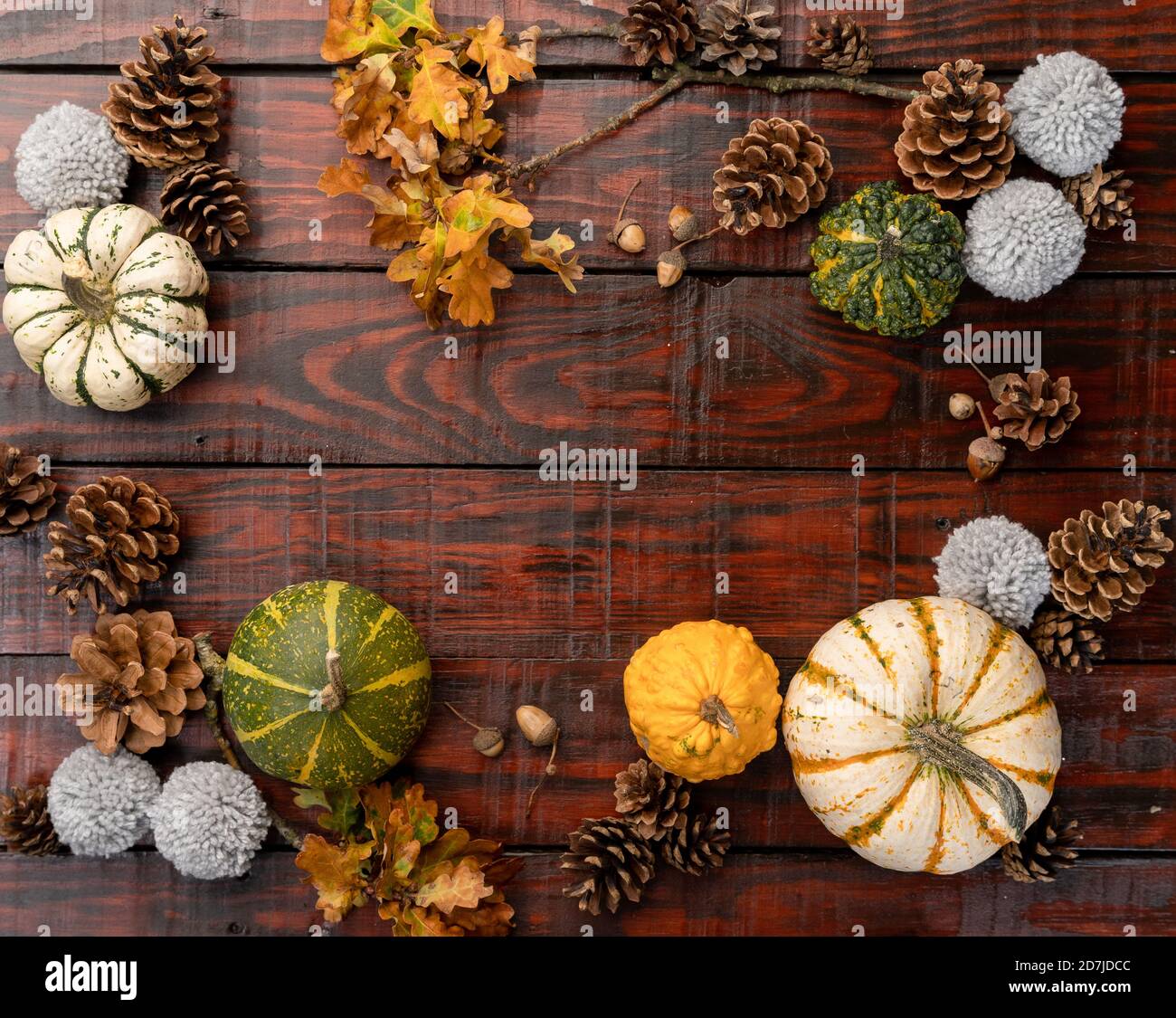 Pumpkins and pinecones on wooden surface with space for your text ...