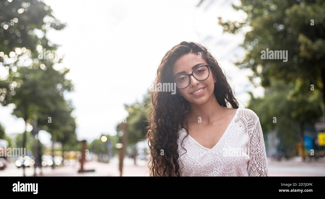 Young woman wearing eyeglasses standing against clear sky Stock Photo