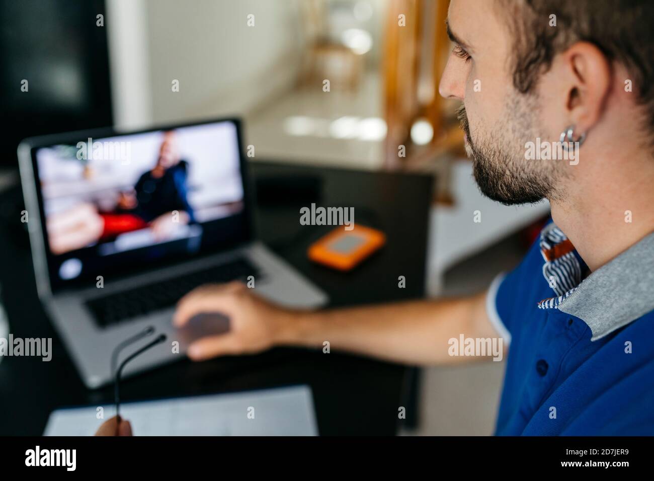 Young man using laptop while studying at home Stock Photo