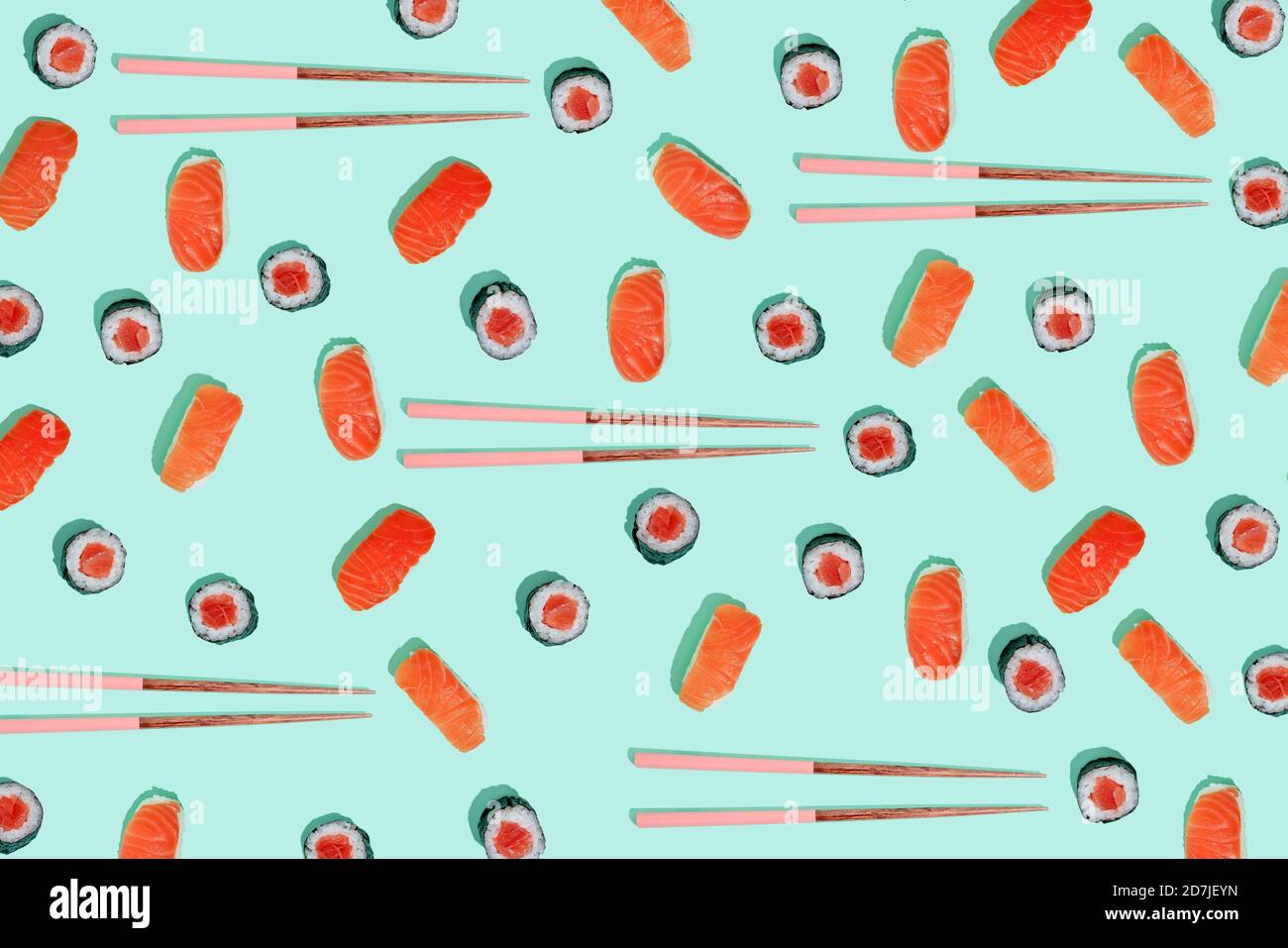 California roll and salman sushi nigiri with chopsticks on mint green background Stock Photo