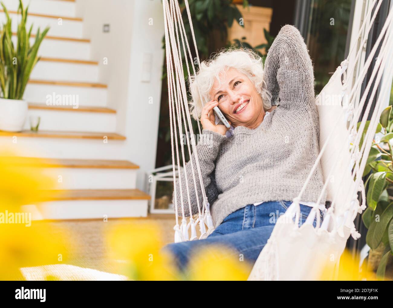Mature woman sitting on swing hi-res stock photography and images - Alamy