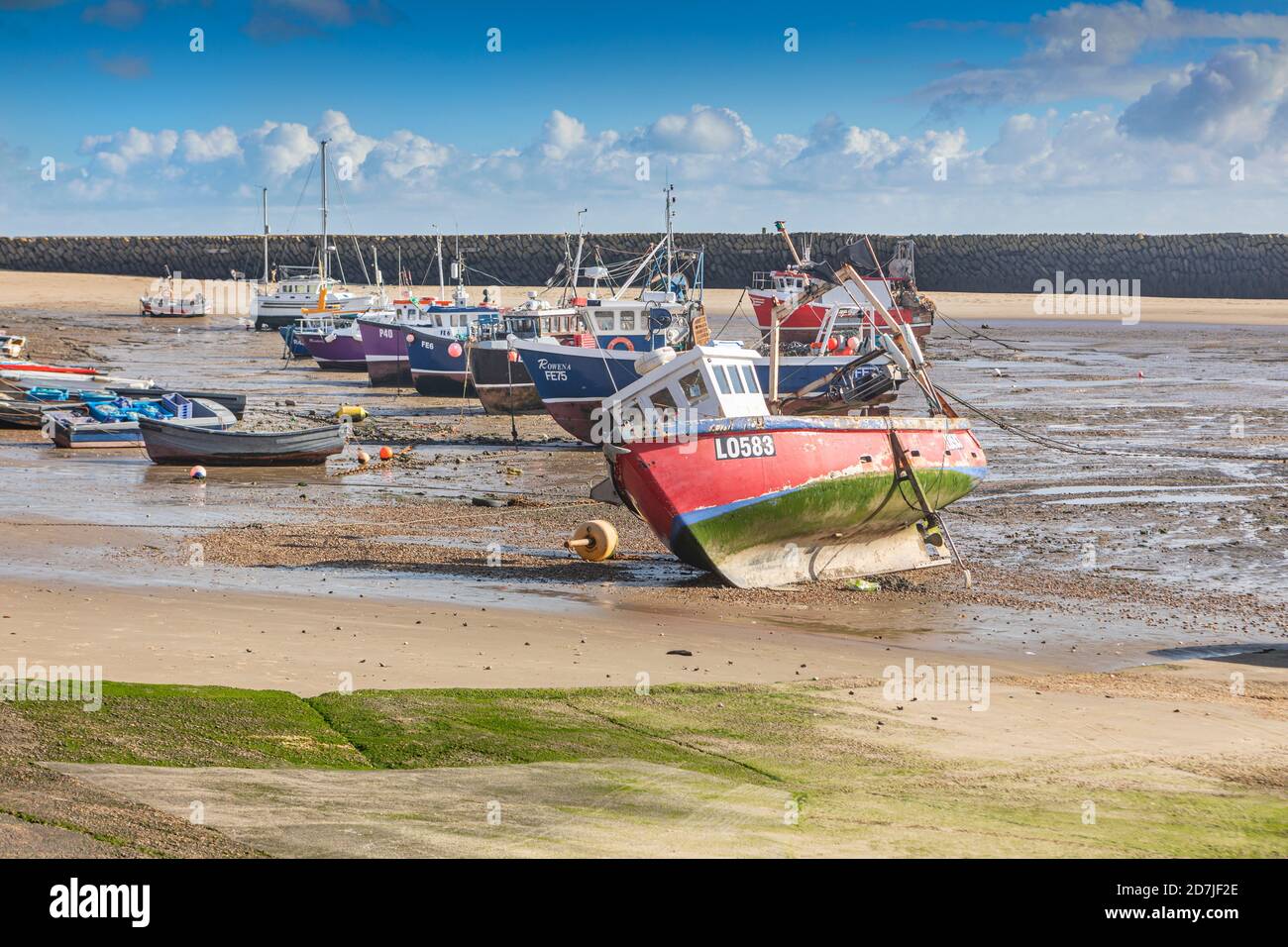 Fishing boats in Folkestone harbour when the tide is out. Stock Photo