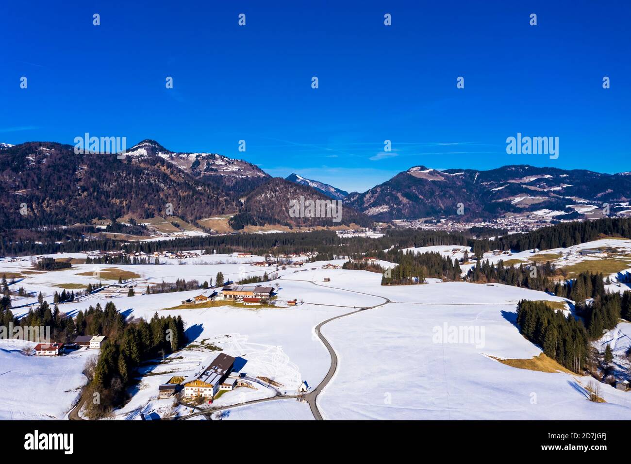 Austria, Tyrol, Kossen, Helicopter view of mountain village in snow-covered Leukental valley Stock Photo