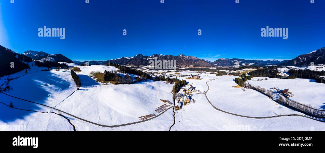 Austria, Tyrol, Kossen, Helicopter panorama of mountain village in snow-covered Leukental valley Stock Photo