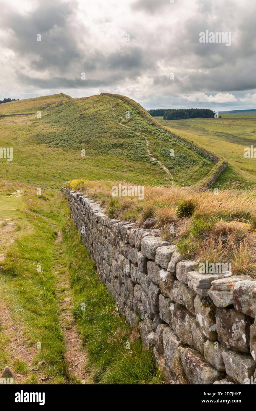 UK, England, Hexham, Clouds over green grassy hills and part of Hadrians Wall Stock Photo