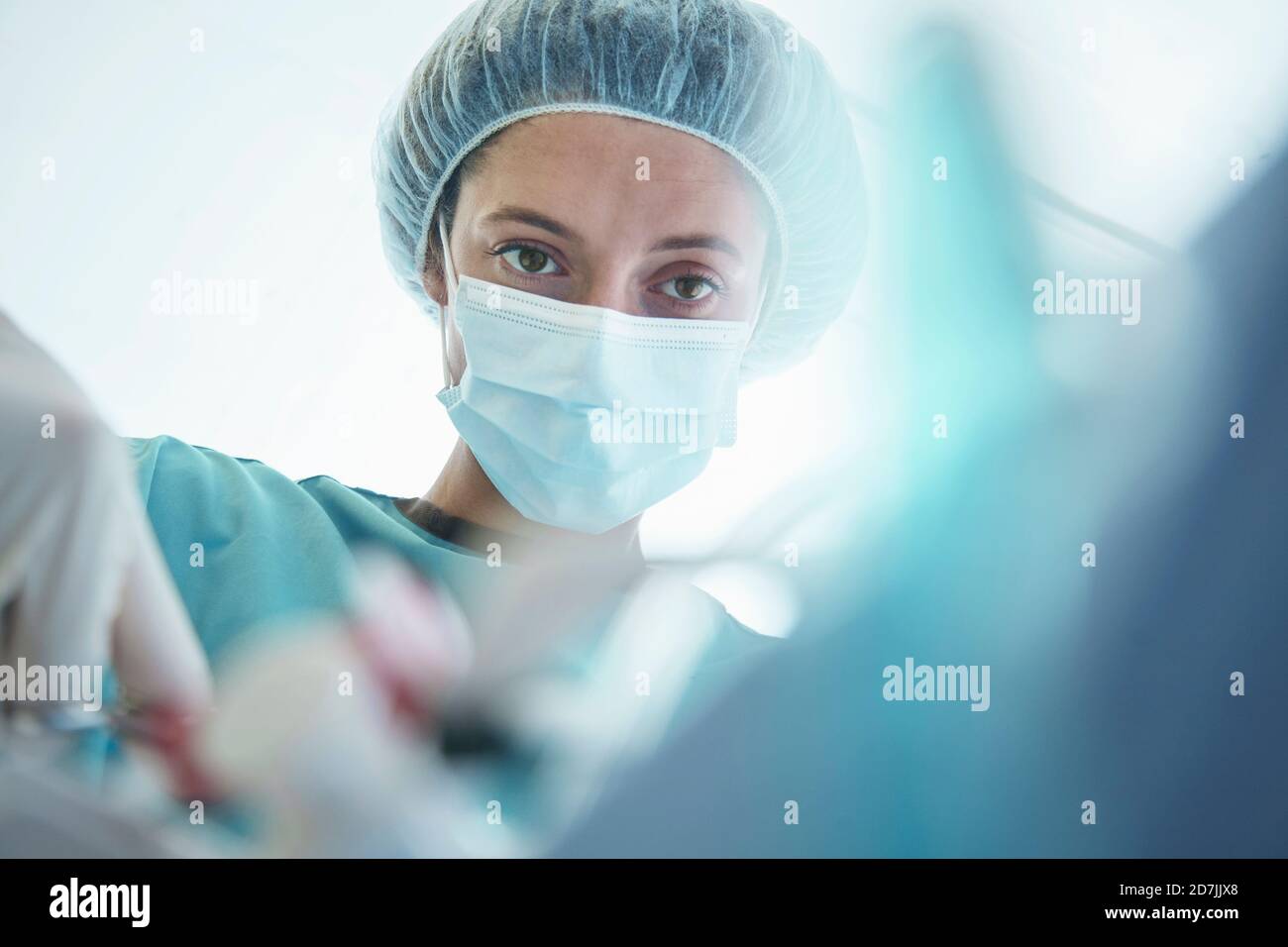 Confident female surgeon operating in intensive care unit at hospital Stock Photo