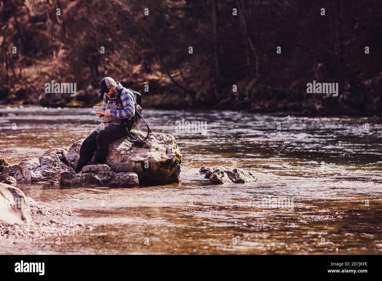 Man sitting on rock fishing hi-res stock photography and images - Alamy