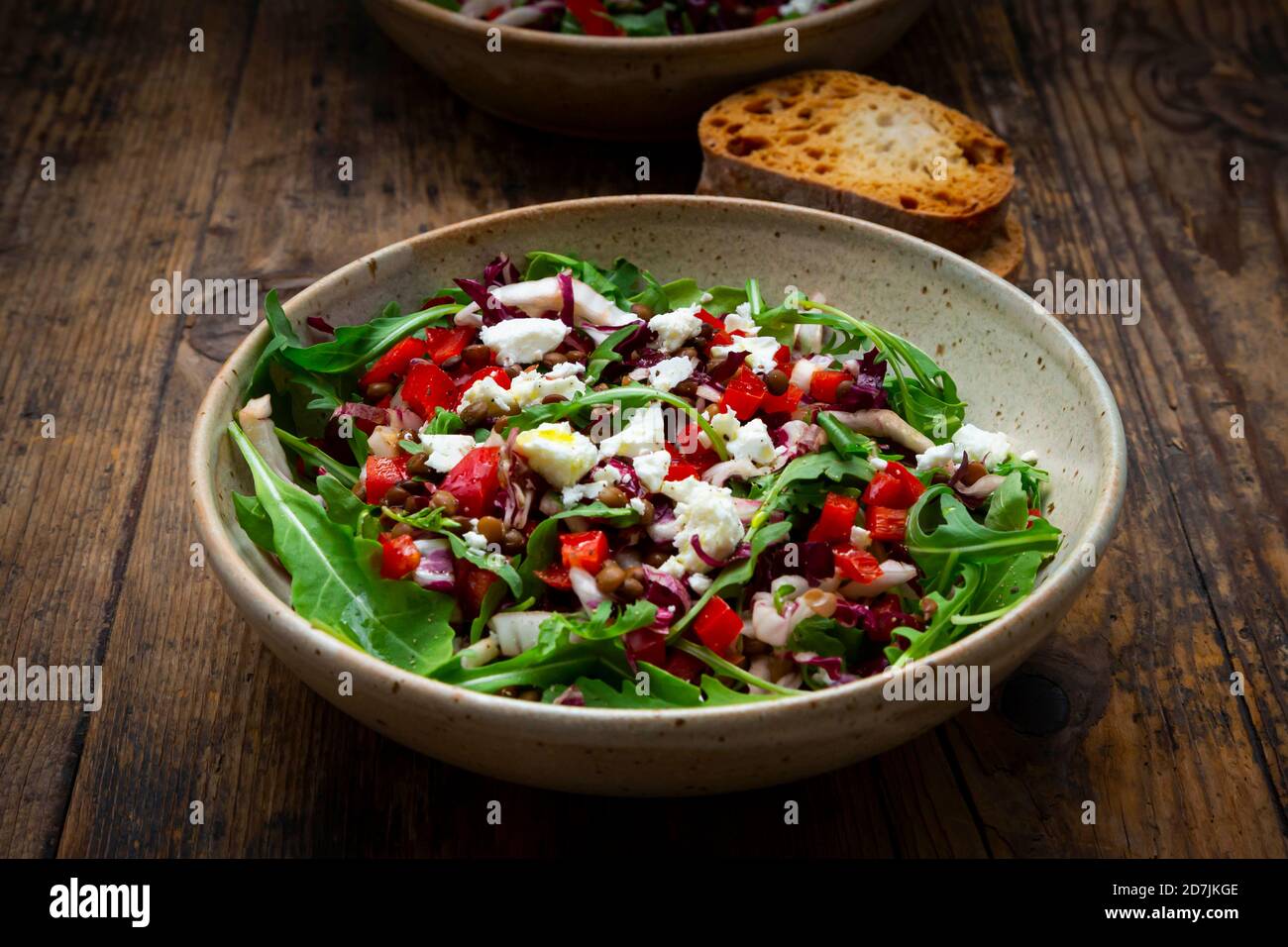 Bowl of vegetable salad with lentils, arugula, red bell pepper, feta cheese and radicchio Stock Photo