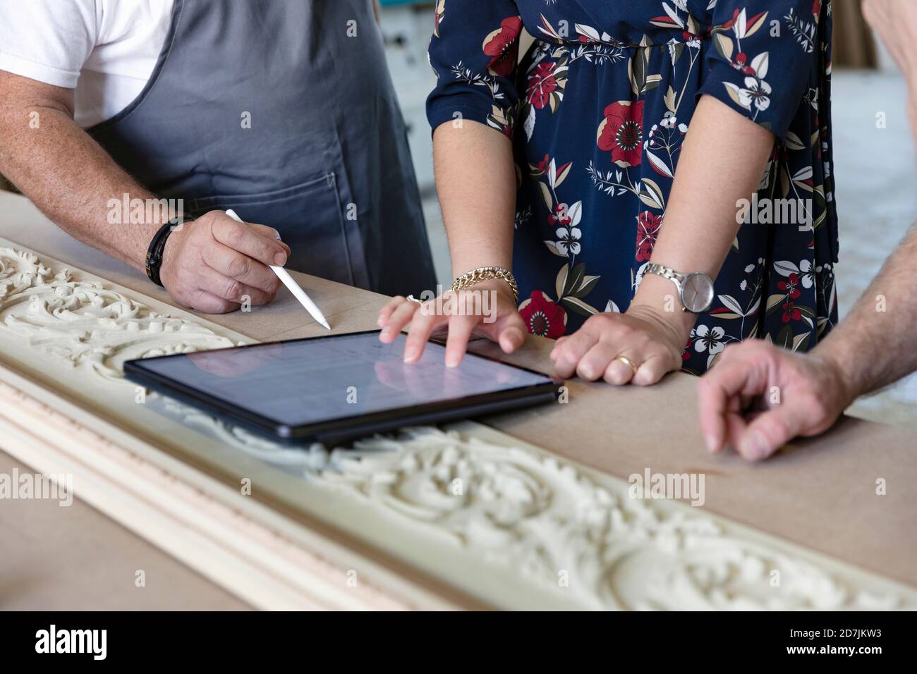 Carpenter and designer using digital tablet at workshop Stock Photo