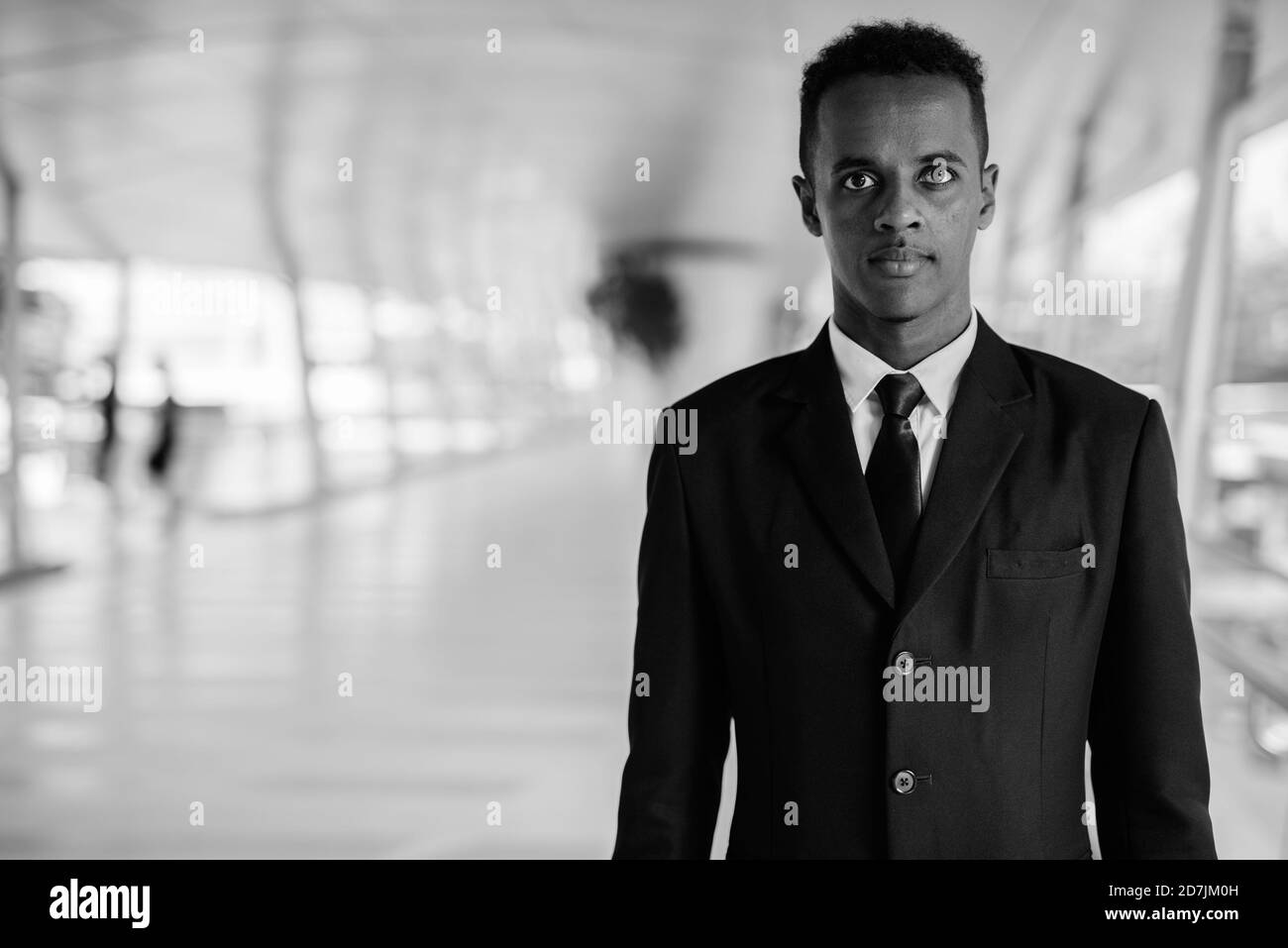 Young African businessman in suit exploring the city Stock Photo