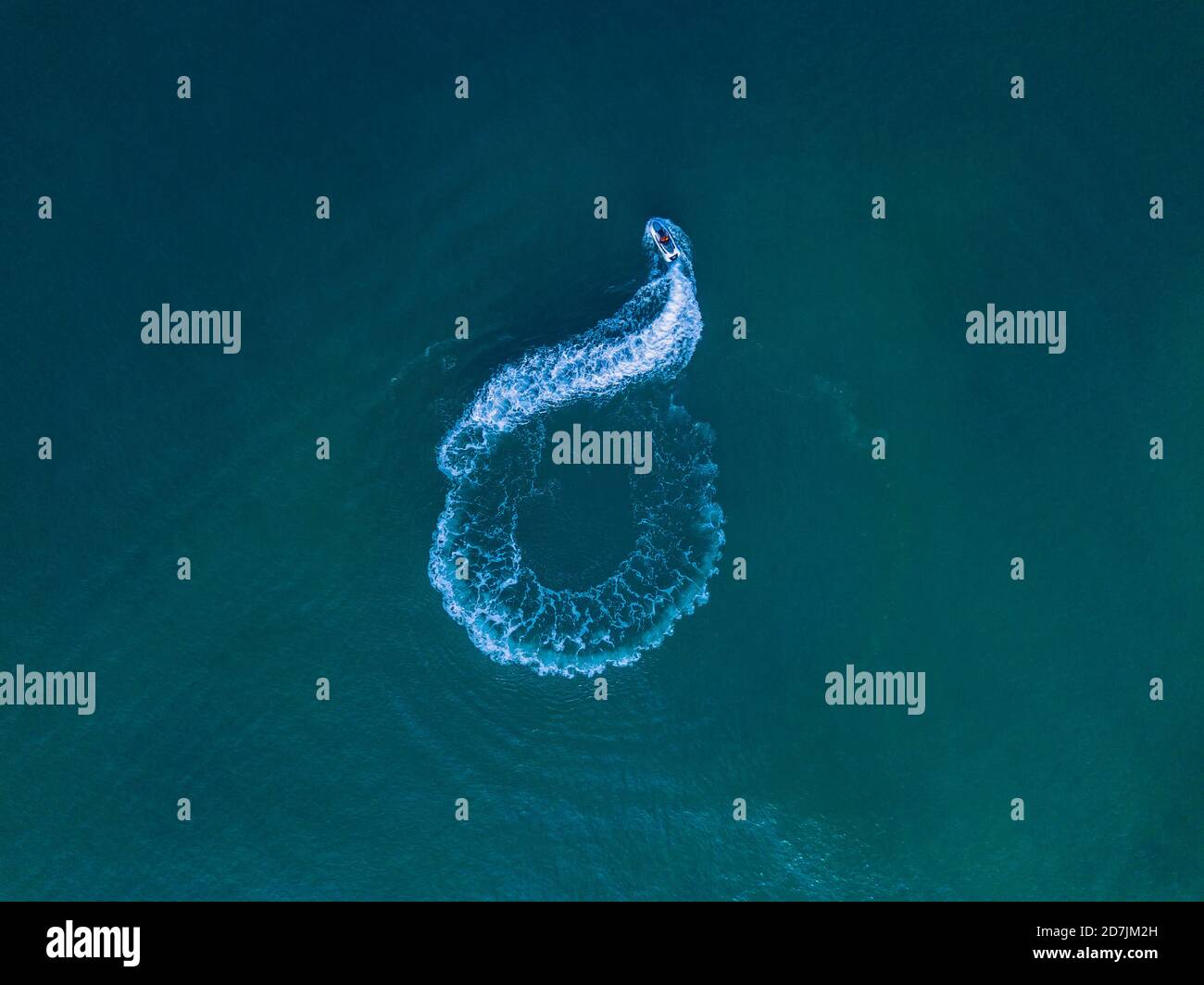 Aerial view of jet boat sailing in turquoise water Stock Photo - Alamy
