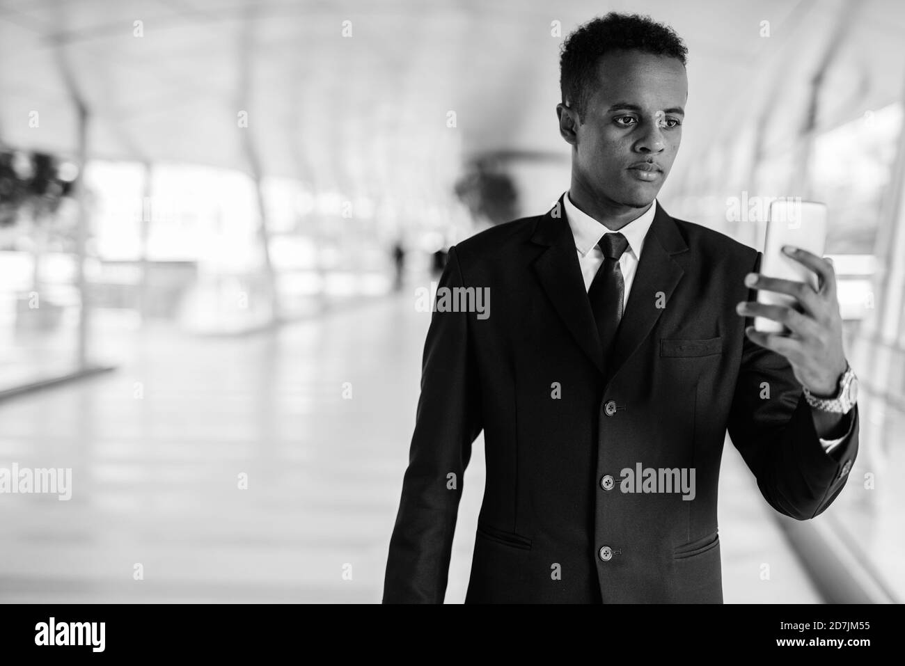 Young African businessman in suit exploring the city Stock Photo